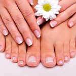 Skincare of a beauty female feet with camomile's flower